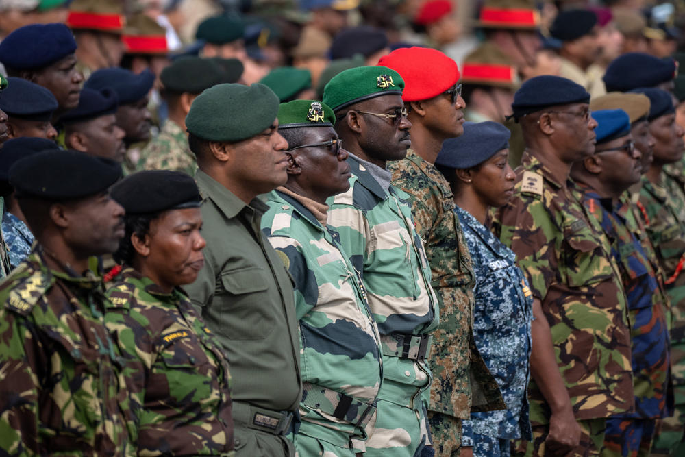 Commonwealth troops wait on Thursday to receive commemorative coins during a military parade in Pirbright, England, for representatives of the Commonwealth taking part in the coronation of King Charles III.
