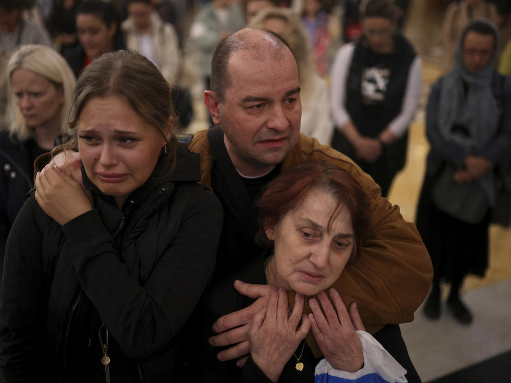People mourn the victims at the St. Sava Serbian Orthodox temple in Belgrade, Serbia, Thursday, May 4, 2023. Hundreds of citizens gathered to pray for the victims, after a 13-year-old on Wednesday killed eight fellow students and a guard.