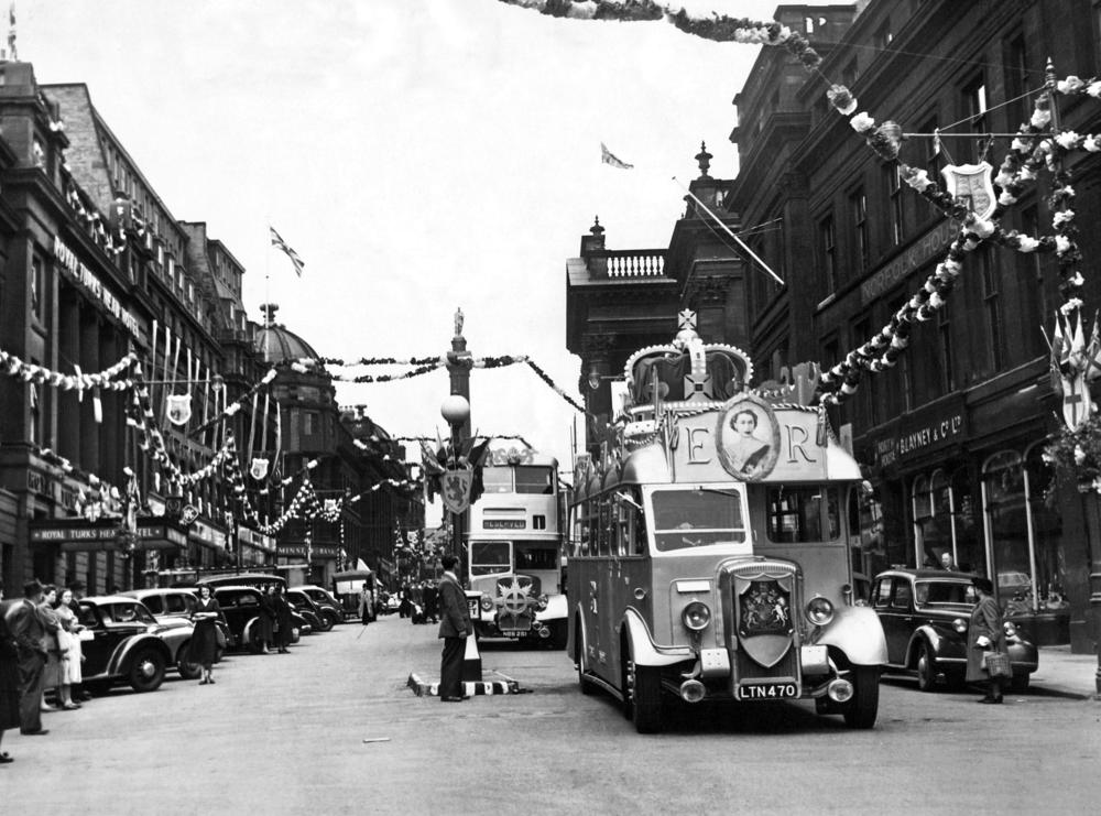 A bus in Newcastle is adorned with Queen Elizabeth's insignia to celebrate her coronation.