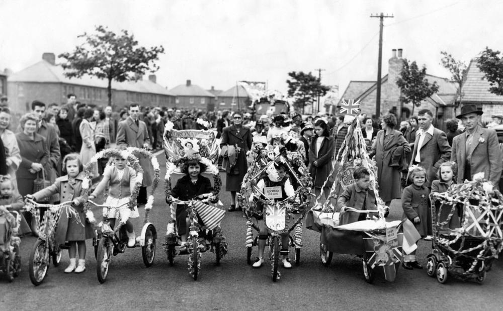 Children enjoy a bicycle race at their North East street party for Queen Elizabeth II's coronation.