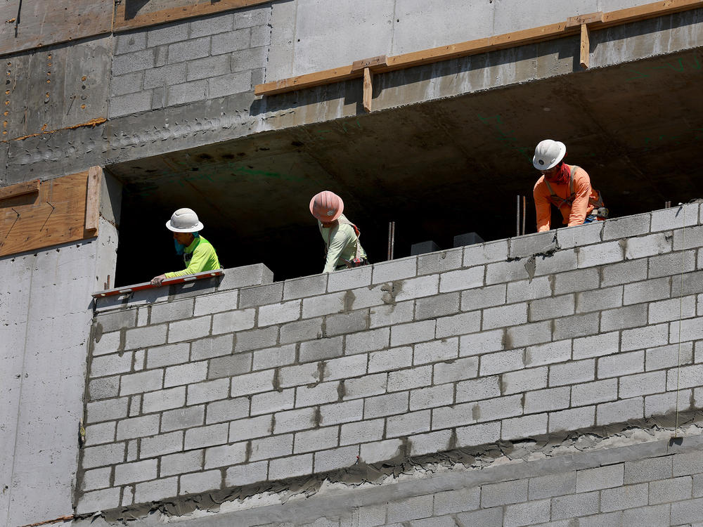 Construction workers on a job site in Miami on March 10, 2023. Although, industries such as construction are particularly sensitive to rising interest rates, builders added 15,000 jobs in April.