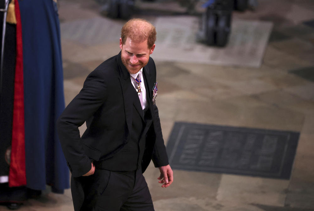 Britain's Prince Harry arrives to attend Britain's King Charles III and Queen Consort Camilla's coronation ceremony, at Westminster Abbey.
