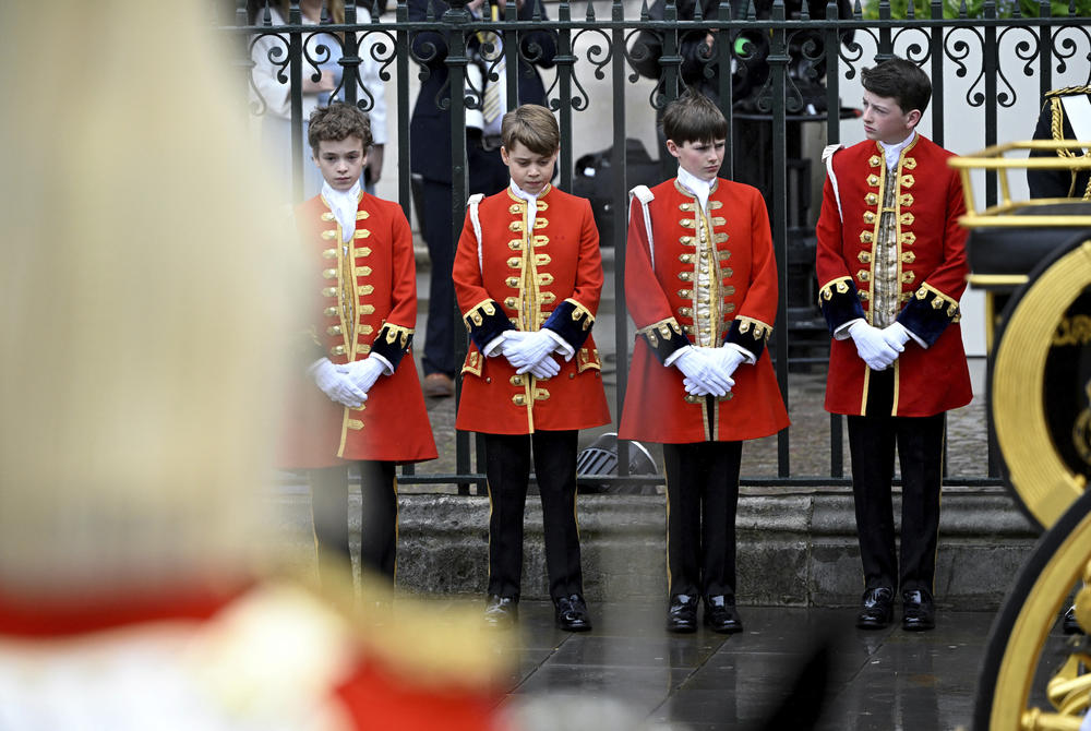 Britain's Prince George, second left, stands at Westminster Abbey.