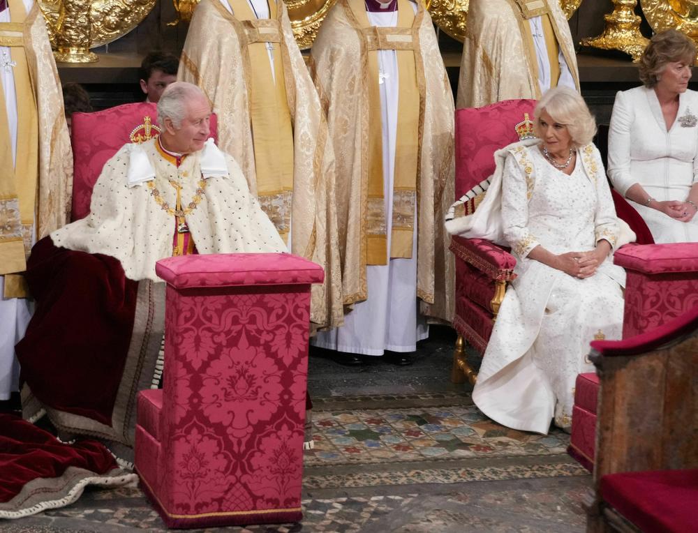 Britain's King Charles III (L) and Britain's Camilla, Queen Consort, exchange a look during the Coronation ceremony. Outside the UK, he is also king of 14 other Commonwealth countries, including Australia, Canada and New Zealand.