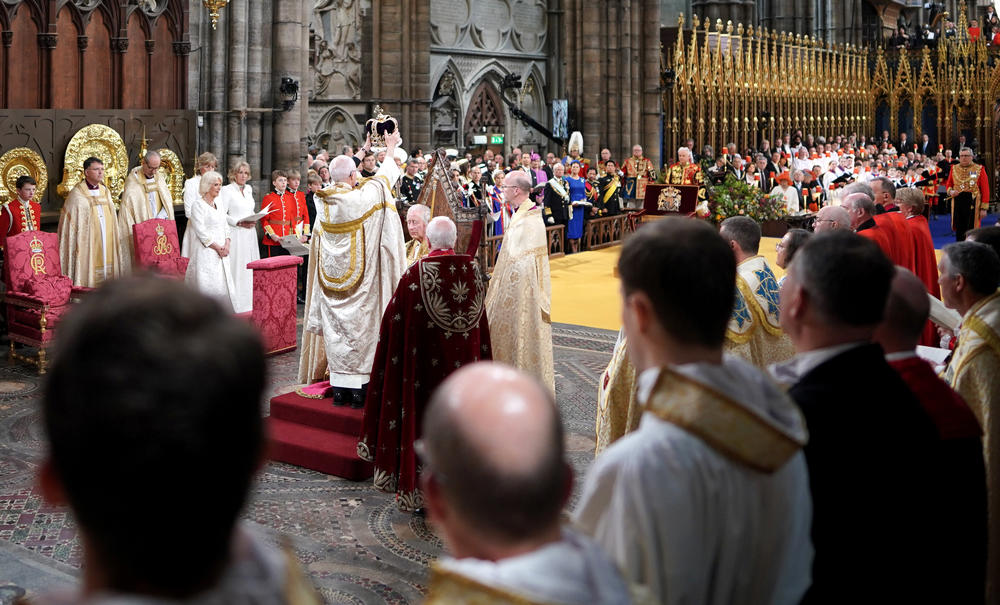 King Charles III is crowned with St Edward's Crown by The Archbishop of Canterbury the Most Reverend Justin Welby as Camilla, Queen Consort looks on during his coronation ceremony.