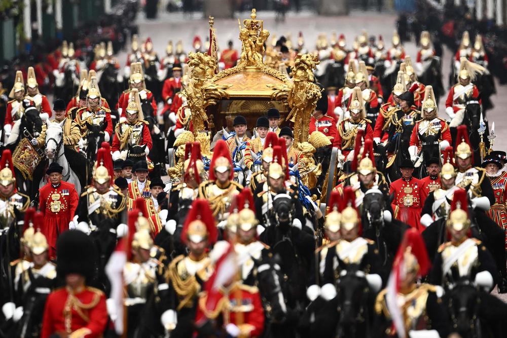 Britain's Queen Camilla and Britain's King Charles III travel in the Gold State Coach, back to Buckingham Palace from Westminster Abbey.