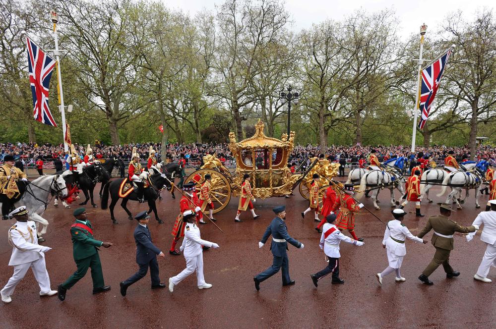 Britain's Queen Camilla and Britain's King Charles III travel in the Gold State Coach, back to Buckingham Palace from Westminster Abbey.