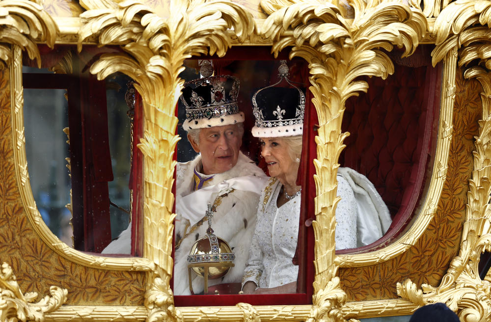 King Charles III and Queen Camilla travel in the Gold State Coach built in 1760 and used at every Coronation since that of William IV in 1831.