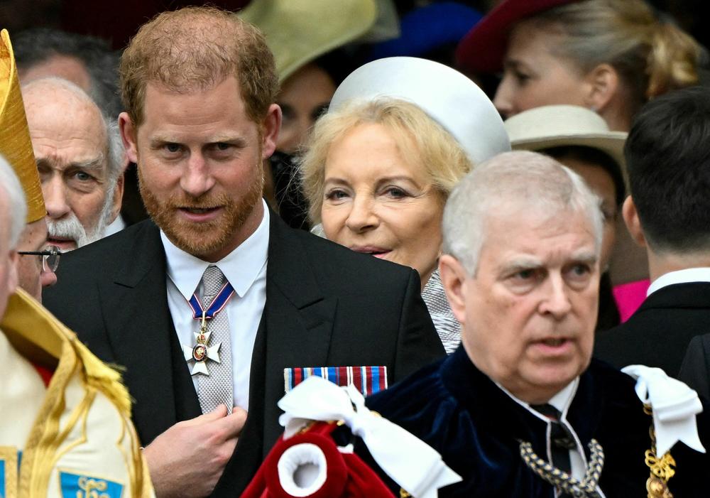 Britain's Prince Harry, Duke of Sussex (Left) and Britain's Prince Andrew, Duke of York (Right) leave after attending the coronations of Britain's King Charles III and Britain's Queen Camilla at Westminster Abbey.