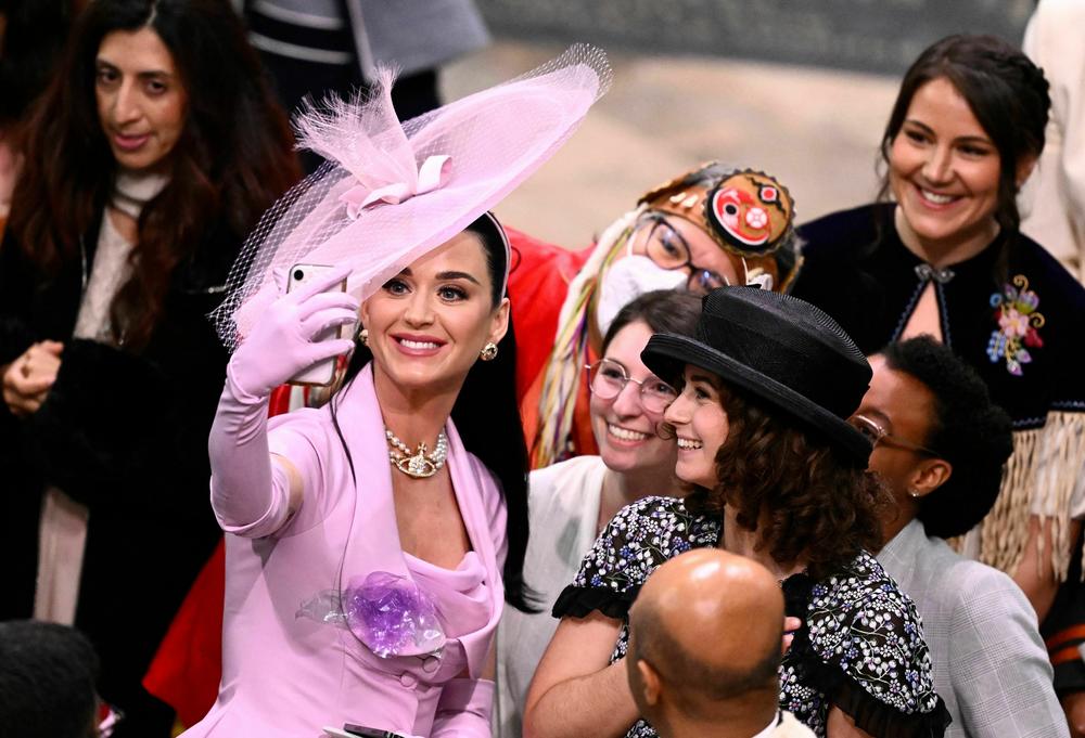 American singer-songwriter Katy Perry takes selfie photos with guests at Westminster Abbey.