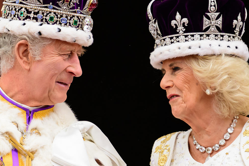 Britain's King Charles III looks at Queen Camilla as they stand on the Buckingham Palace balcony, in London, following their coronations.