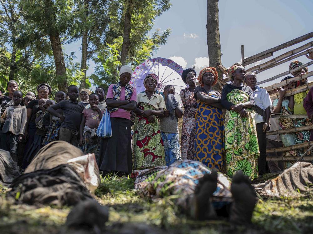 Relatives gather to identify bodies in the village of Nyamukubi, South Kivu province, Congo, Saturday, May 6, 2023.