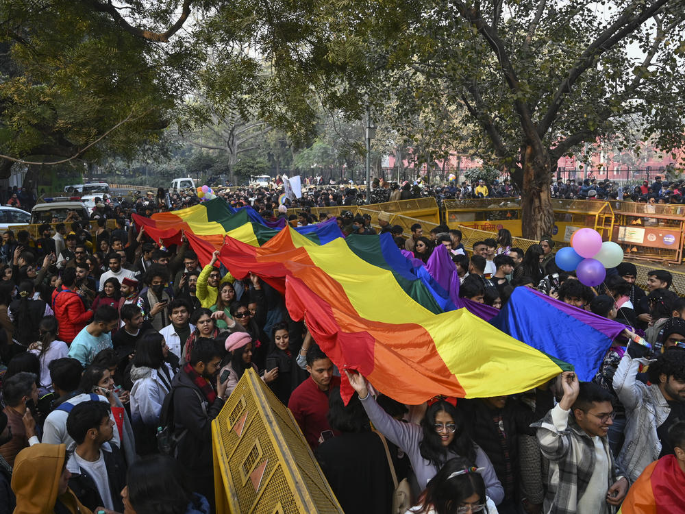 Members of the LGBTQ+ community and their supporters carry a rainbow flag as they march demanding equal marriage rights in New Delhi, India, in January. The Supreme Court in 2018 struck down a colonial-era law that made gay sex punishable by up to 10 years in prison, and is now hearing arguments in a case to legalize same-sex marriage.