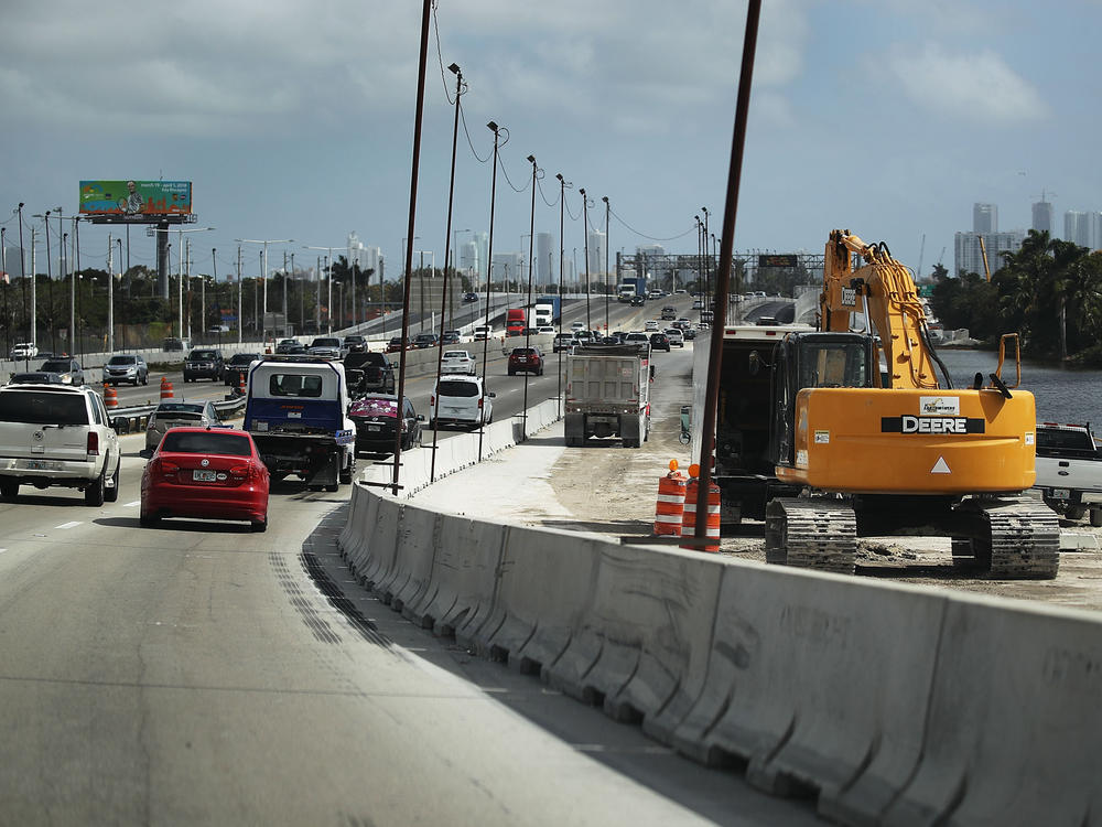 Construction workers build along State Road 836 in 2018 in Miami. HB 1191 would compel the Florida Transportation Department to study using phosphogypsum in paving projects.