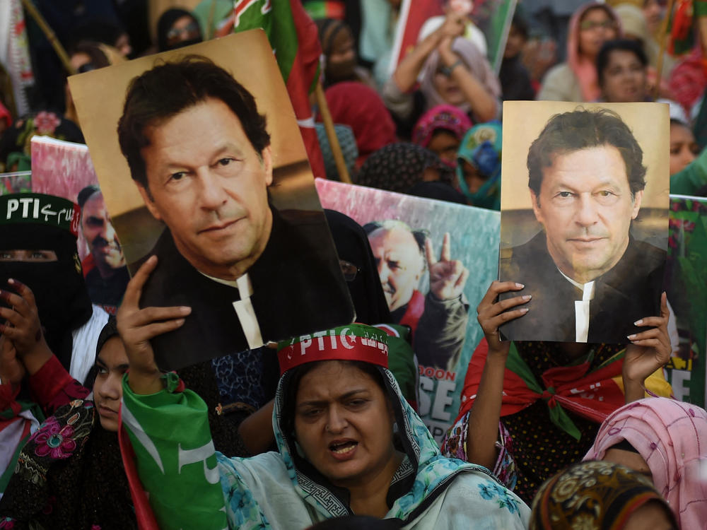 Supporters carry placards displaying a portrait of Imran Khan during a protest in Karachi on March 19, demanding release of arrested party workers in recent police clashes.