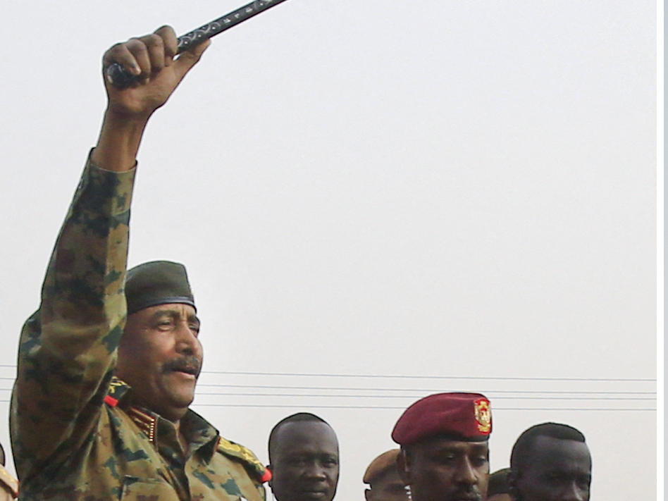 Gen. Abdel Fattah Burhan (left), the head of Sudan's ruling military council, greets supporters near the capital Khartoum in 2019. Sudanese paramilitary commander Gen. Mohammed Dagalo, widely known as Hemedti, is shown on the right, in the capital earlier this month. The generals have been fighting for control of Sudan for nearly a month, leaving more than 500 dead.