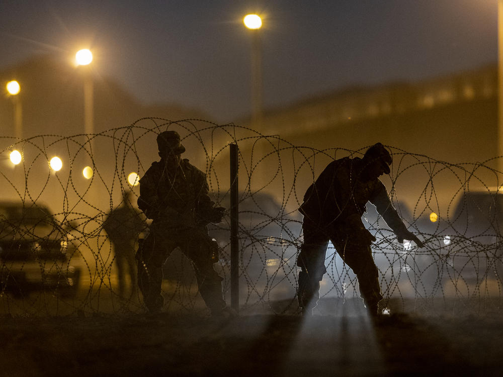 Texas National Guard troops set up razor wire in El Paso, Texas. Officials are anticipating a wave of immigrants on Thursday night, with the end of the U.S. government's COVID-era Title 42 policy.