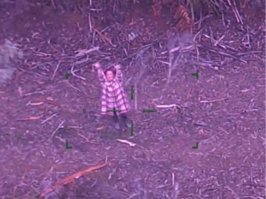 A screenshot shows the moment Lillian, a 48-year-old Australian woman, was rescued after going missing in dense bushland with only a bottle of wine and some candy.