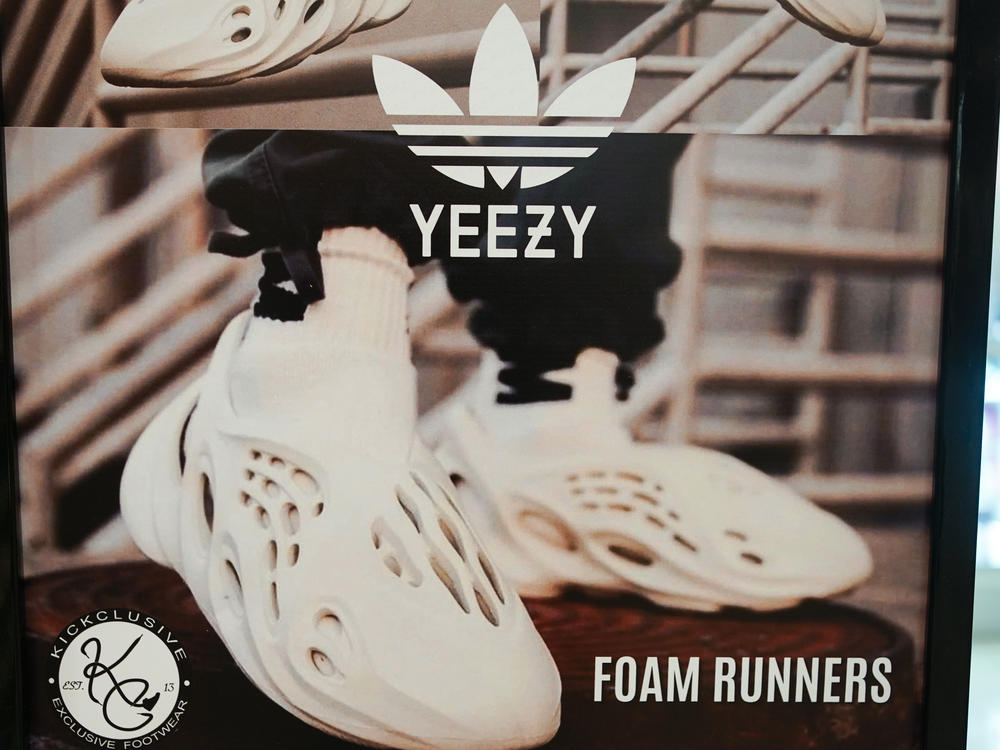 A sign advertises Yeezy shoes made by Adidas at a store in Paramus, N.J., on Oct. 25, 2022. After cutting ties with Ye, formerly known as Kanye West, Adidas now plans to sell its stock of unsold Yeezy shoes and donate the proceeds to charity.