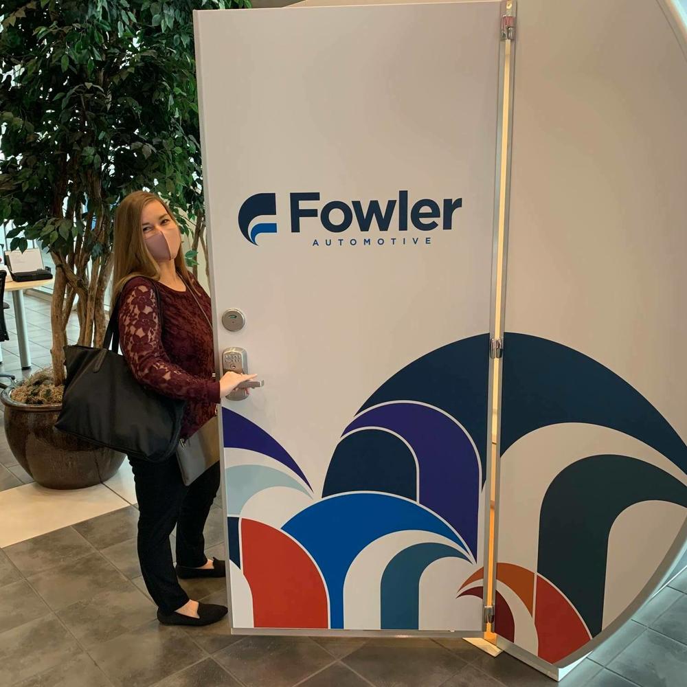 A Fowler Automotive employee standing next to one of eight the lactation pods Jonathan Fowler purchased.