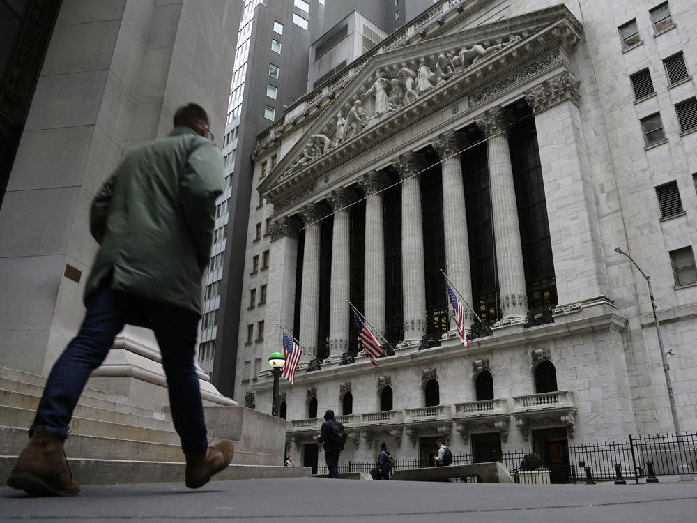 People pass the front of the New York Stock Exchange in New York, on March 22. Brinkmanship in Washington over raising the U.S. debt ceiling has begun to raise worries in parts of the financial markets.
