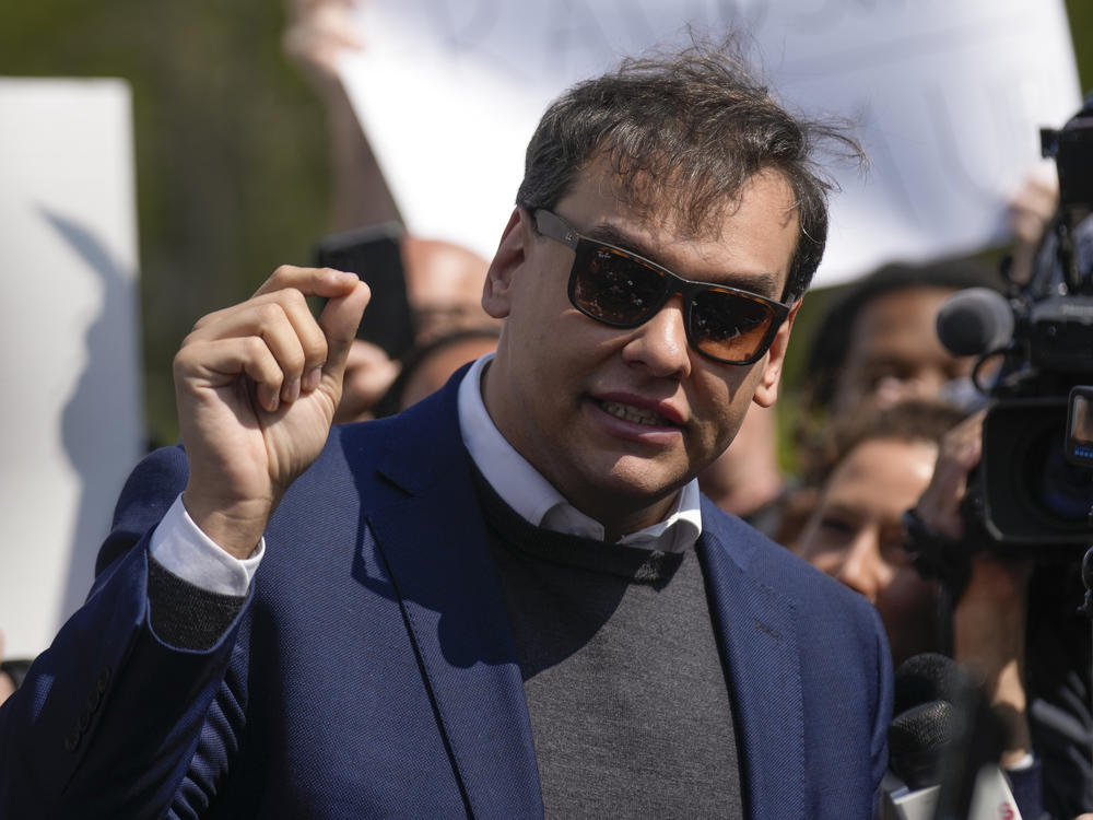 U.S. Rep. George Santos, R-N.Y., speaks to the media outside the federal courthouse in Central Islip, N.Y., Wednesday. The next day, he appeared virtually in a Brazilian court to face separate charges.