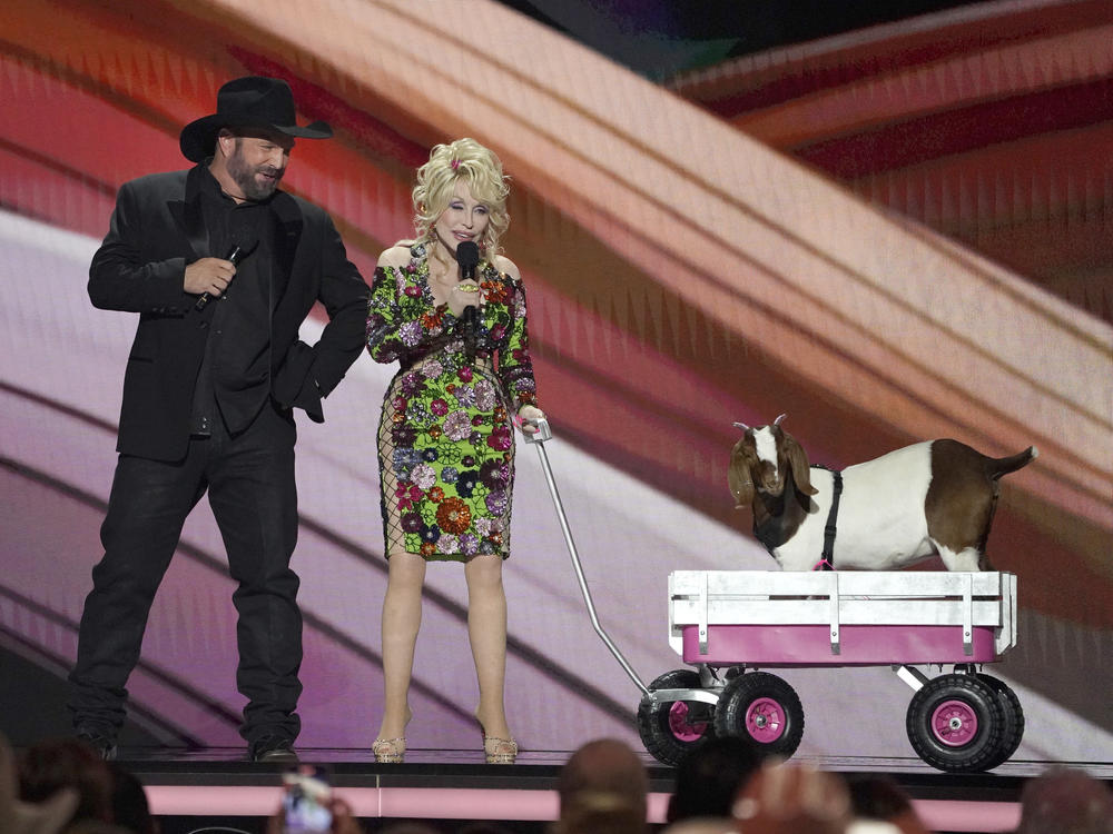 Hosts Garth Brooks, left, and Dolly Parton speak on stage with a goat at the 58th annual Academy of Country Music Awards on Thursday, May 11, 2023, at the Ford Center in Frisco, Texas.