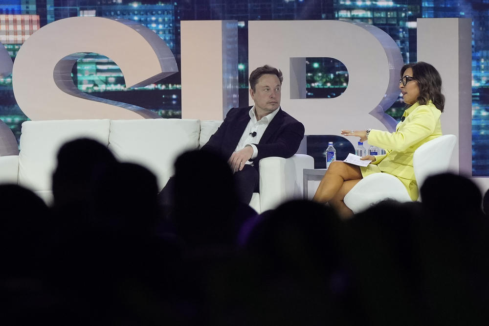 Elon Musk speaks with Linda Yaccarino, then-chairman of global advertising and partnerships for NBC, at the POSSIBLE marketing conference on April 18 in Miami Beach, Fla.