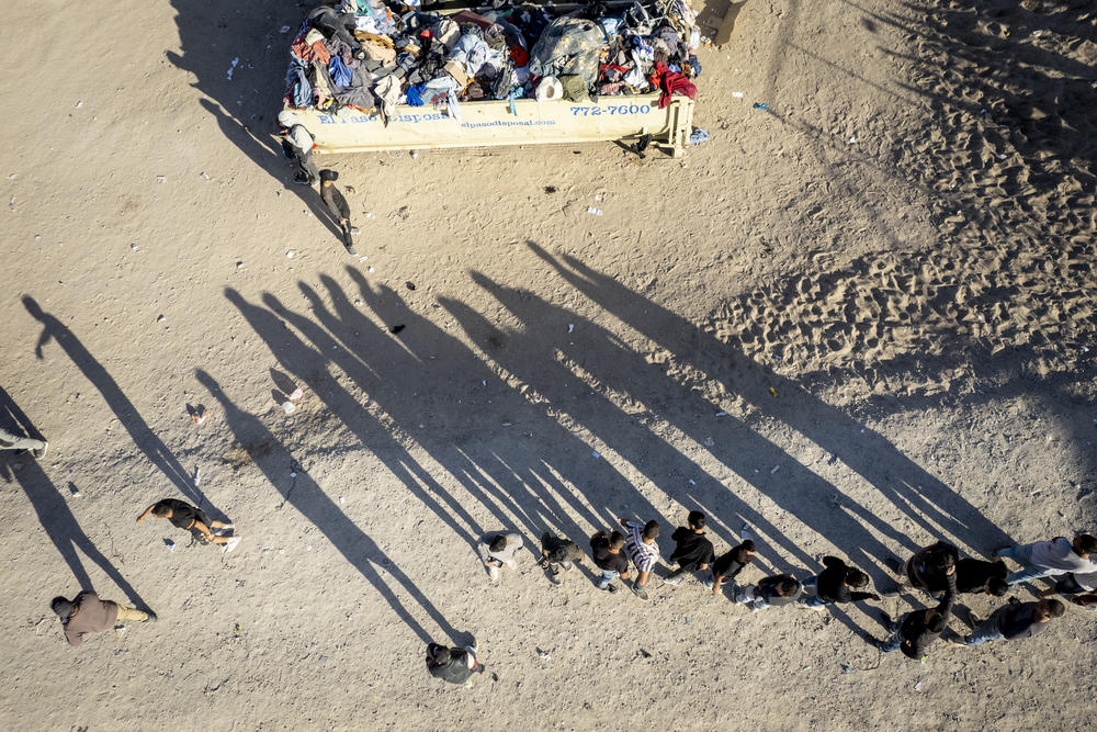 As seen from an aerial view, immigrants line up to be processed by U.S. Border Patrol agents at the U.S.-Mexico border on Friday, in El Paso, Texas.
