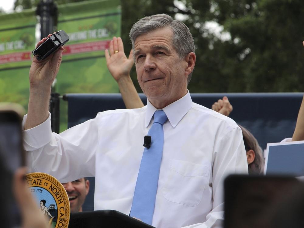 North Carolina Democratic Gov. Roy Cooper affixes his veto stamp to a bill banning nearly all abortions after 12 weeks of pregnancy at a public rally on Saturday in Raleigh, N.C.
