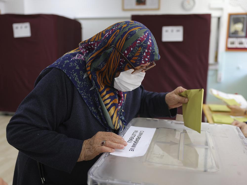 A woman votes at a polling station in Ankara, Turkey, Sunday, May 14, 2023. Voters in Turkey go to the polls on Sunday for pivotal parliamentary and presidential elections that are expected to be tightly contested and could be the biggest challenge Turkish President Recep Tayyip Erdogan faces in his two decades in power.