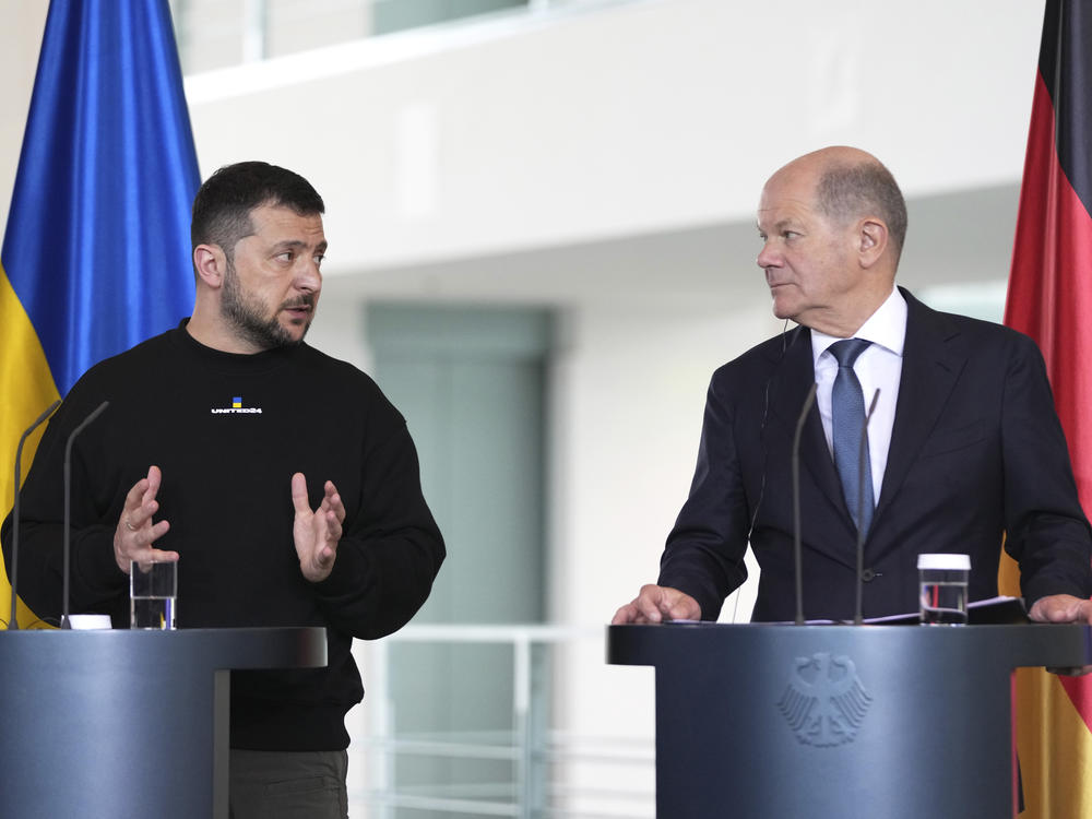 Germany's Chancellor Olaf Scholz, right, and Ukraine's President Volodymyr Zelenskyy address a media conference at the chancellery in Berlin, Germany, Sunday, May 14, 2023. Ukrainian President Volodymyr Zelenskyy arrived in Berlin early Sunday for talks with German leaders about further arms deliveries to help his country fend off the Russian invasion and rebuild what's been destroyed in the war.