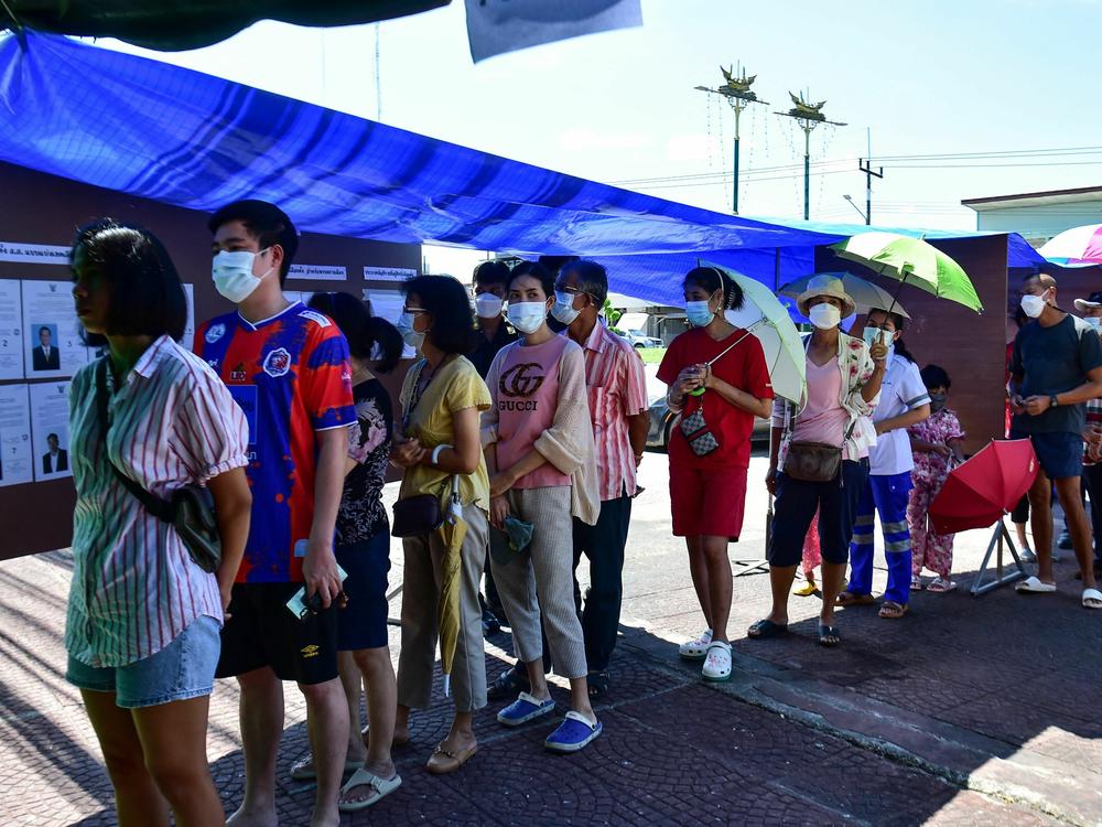 Voters wait in a queue to cast their ballot at a polling station during the country's general election in Narathiwat, southern Thailand, on May 14, 2023.
