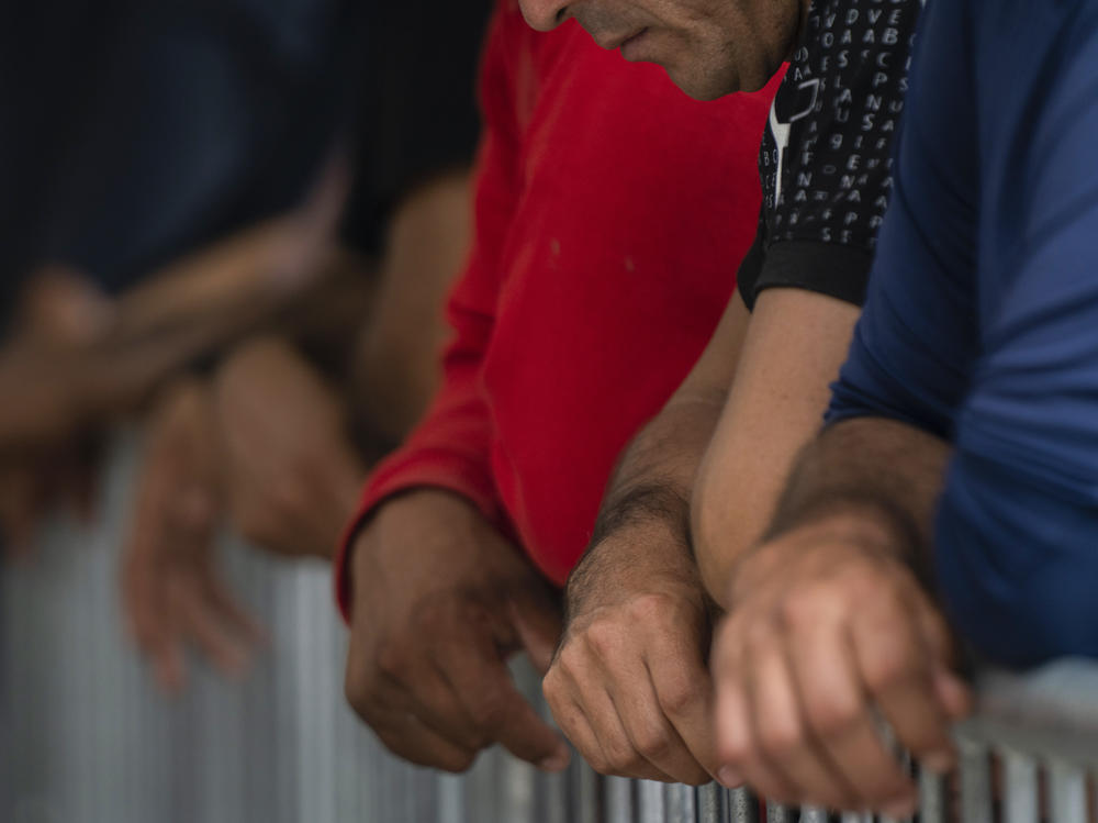 Migrants wait at the Gateway International port of entry under U.S. Customs and Border Protection custody in Brownsville, Texas, on May 5, before being sent back to Mexico under then-active Title 42 restrictions.