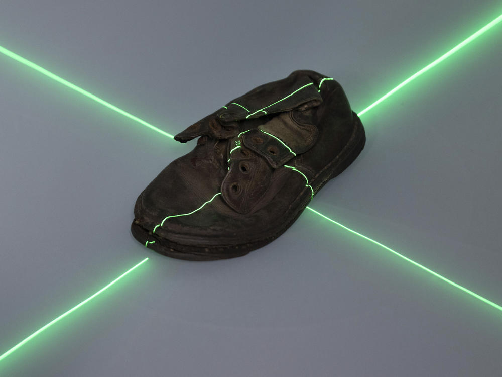 A shoe that belonged to a child victim of the former Nazi German death camp Auschwitz-Birkenau is scanned at the conservation laboratory on the grounds of the camp in Oswiecim, Poland, Wednesday, May 10, 2023. Most of the victims were Jews killed in dictator Adolf Hitler's attempt to exterminate the Jews of Europe.