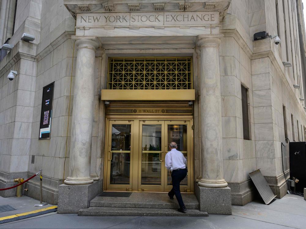 A man enters the New York Stock Exchange on Wall Street in New York City on Friday.
