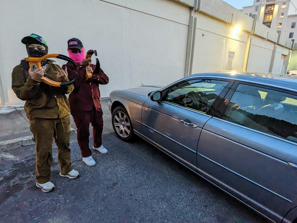 Boot Baby, who wears a black balaclava, and Boot Sheisty, in pink, have built a following of more than 85,000 across Instagram and TikTok through their boot removal business in Atlanta.