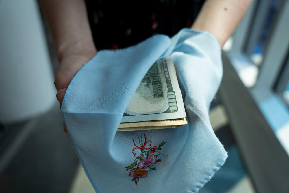 NPR's Alina Selyukh shows how she wrapped tuition money in this handkerchief before safety-pinning it inside her pocket when she traveled to the U.S. for college in the late 2000s.