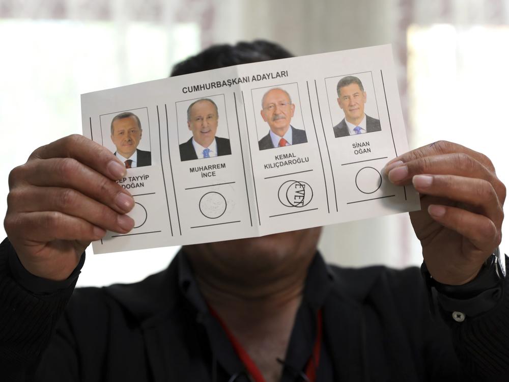 An election representative shows a ballot depicting a vote for Kemal Kilicdaroglu at a polling station in Ankara, Turkey, on Sunday.