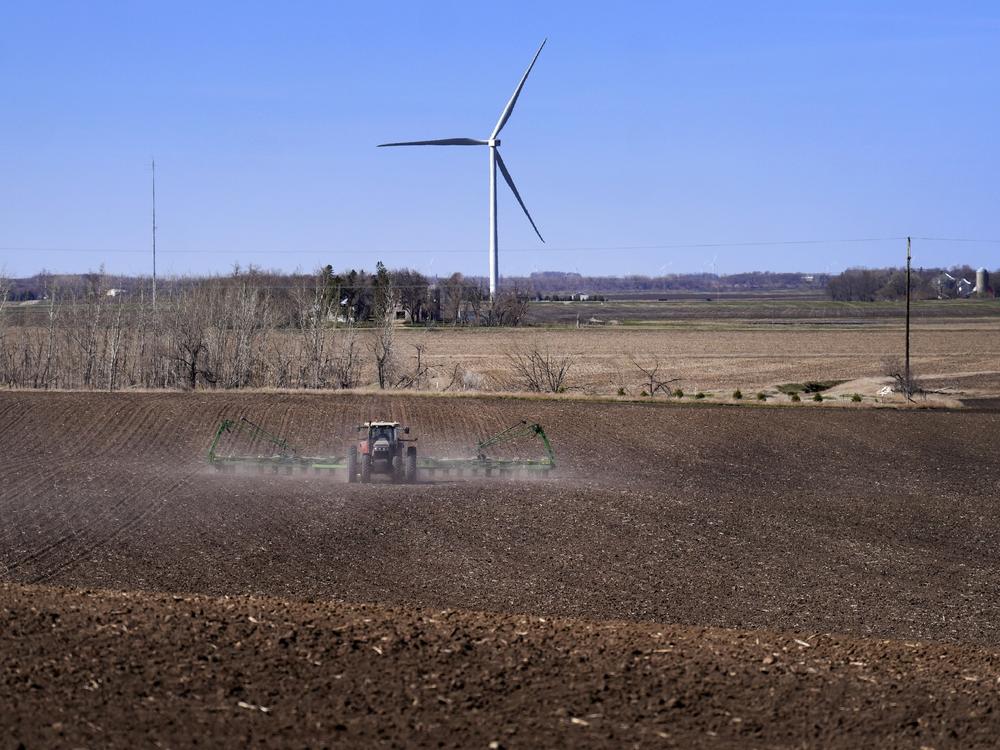 Corn is planted with a view of wind turbines on April 2, in Lake Benton, Minn. The U.S. Department of Agriculture announced a nearly $11 billion investment on Tuesday to help bring affordable clean energy to rural communities throughout the country.
