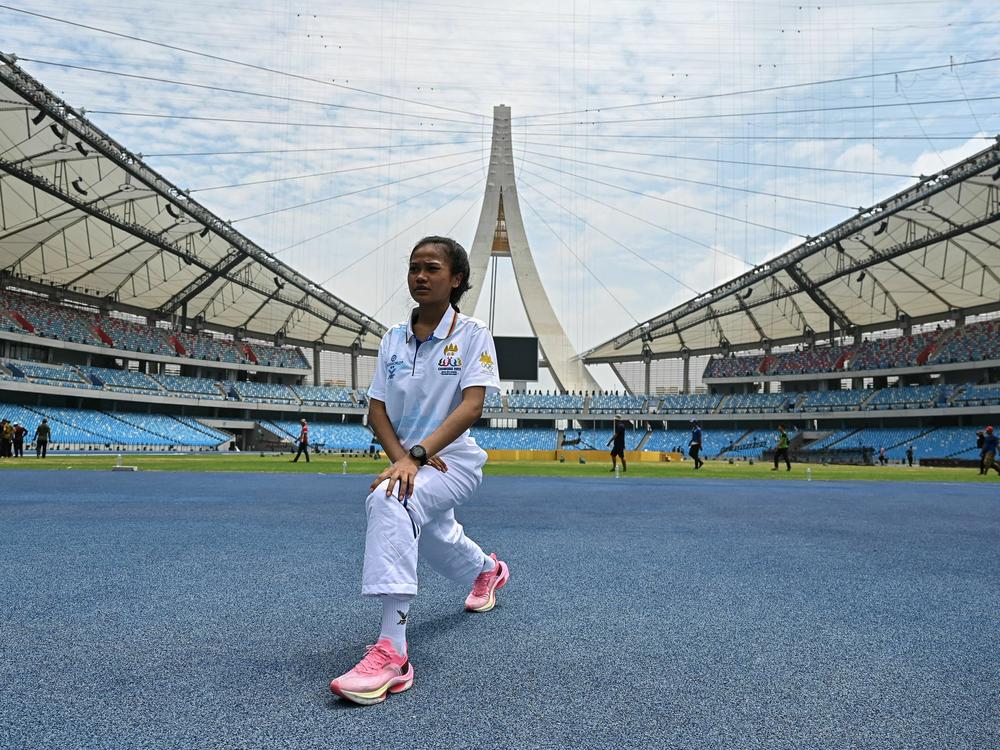 Cambodia's Bou Samnang stretches before training in the country's capital, Phnom Penh, on Saturday, days after she became an unlikely star at the 32nd Southeast Asian Games.