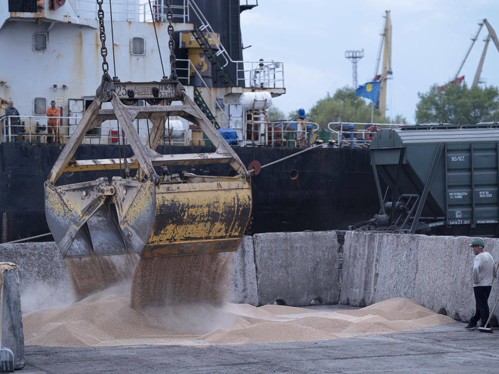 Workers load grain at a port in Izmail, Ukraine, on April 26. A United Nations-backed deal has been extended allowing shipments of Ukrainian grain through the Black Sea to parts of the world struggling with hunger.