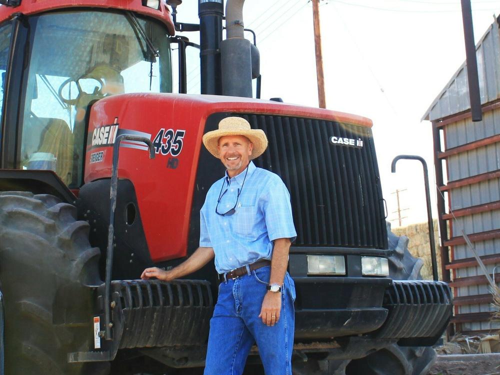 Arizona farmer Craig Alameda stands next to a tractor on his farm near Yuma.