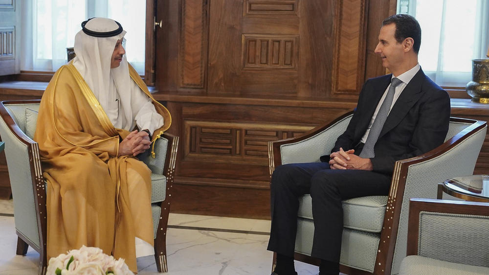 In this photo released by the official Facebook page of the Syrian presidency, Syrian President Bashar Assad (right) meets with Saudi Arabia's Ambassador to Jordan Nayef al-Sadiri, in Damascus, Syria, May 11. Saudi Arabia invited Assad to attend the upcoming Arab League summit.