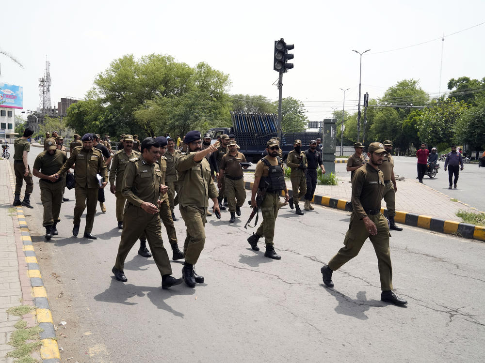 Police officers patrol around the residence of Pakistan's former Prime Minister Imran Khan, in Lahore, Pakistan, Thursday. Pakistani police kept up their siege around the home of Khan as a 24-hour deadline given to the former premier to hand over suspects allegedly sheltered inside was about to expire on Thursday.