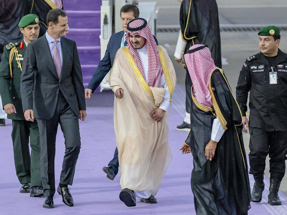 In this photo provided by Saudi Press Agency, Syrian President Bashar Assad (left) is accompanied by Prince Badr bin Sultan, the deputy governor of Mecca, upon his arrival at Jeddah airport, Saudi Arabia, Thursday, ahead of the Arab summit.