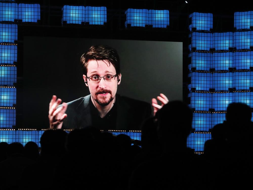 From Moscow, former U.S. National Security Agency contractor Edward Snowden addresses a technology conference in Portugal in 2019. Snowden fled the U.S. in 2013 and revealed highly classified U.S. surveillance programs. He's been living in Russia for the past decade, and received Russian citizenship last year.