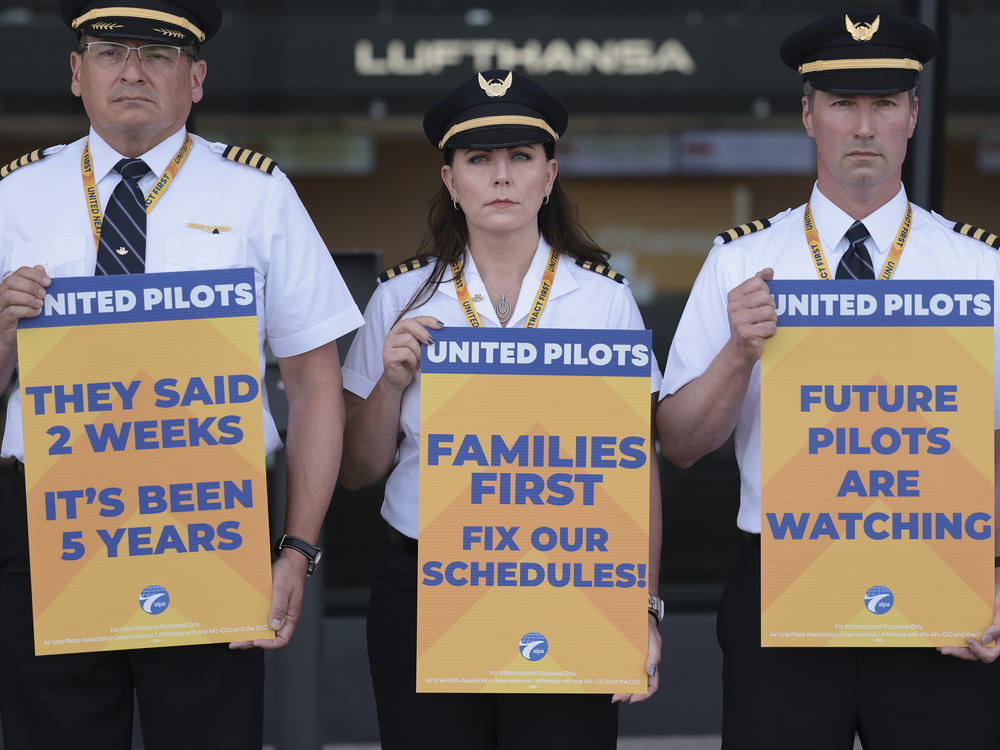 United Airlines pilots participate in a picket line at Washington Dulles International Airport on May 12, 2023. Ahead of a busy summer travel season, they're asking for higher wages and also quality of life improvements.