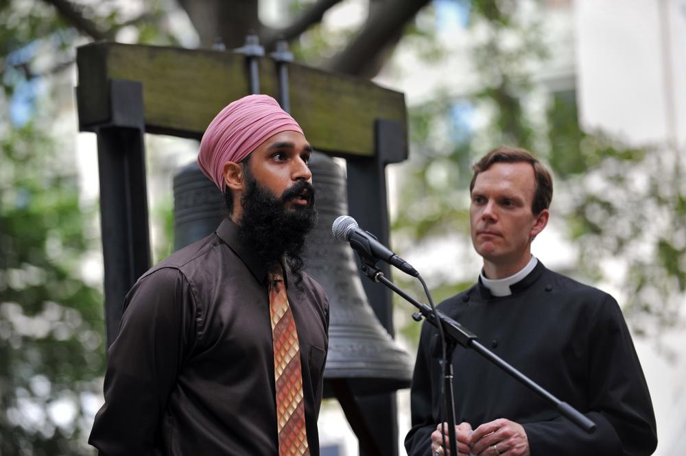 Singh, pictured in 2012, speaks as the Reverend Matthew Heyd of Trinity Wall Street listens before they ring the 