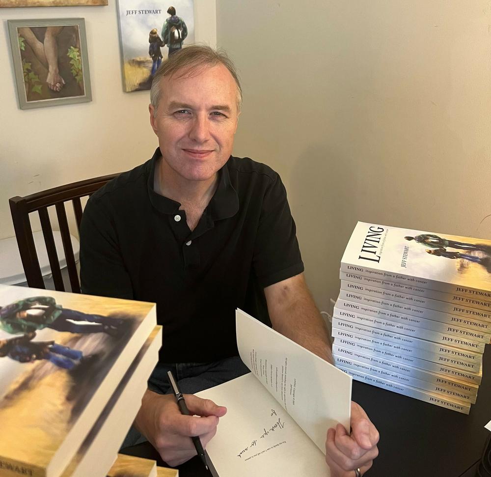The author signs copies of his new book.